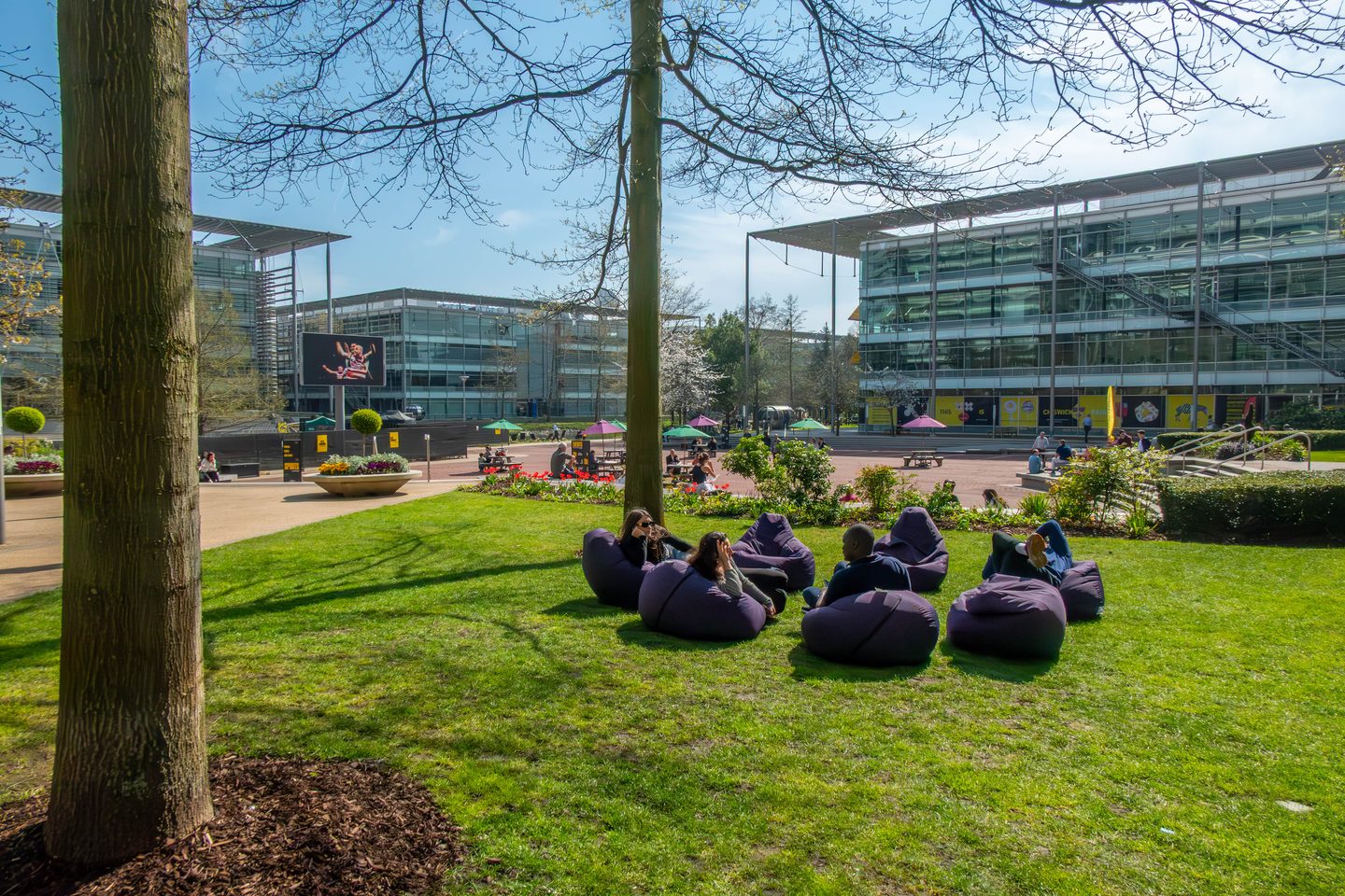 Glazed business park office buildings around a landscaped square